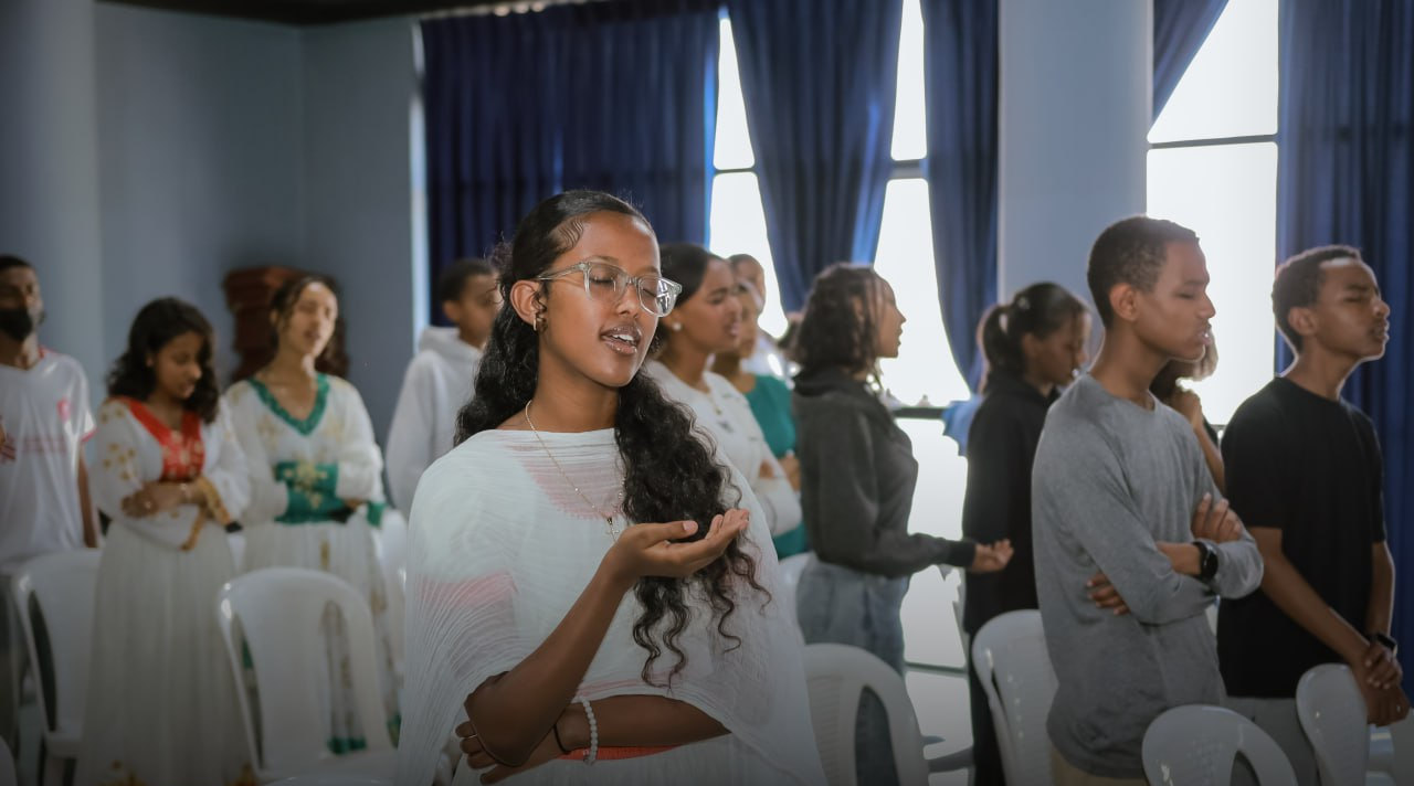 Students worshipping together at a fellowship gathering